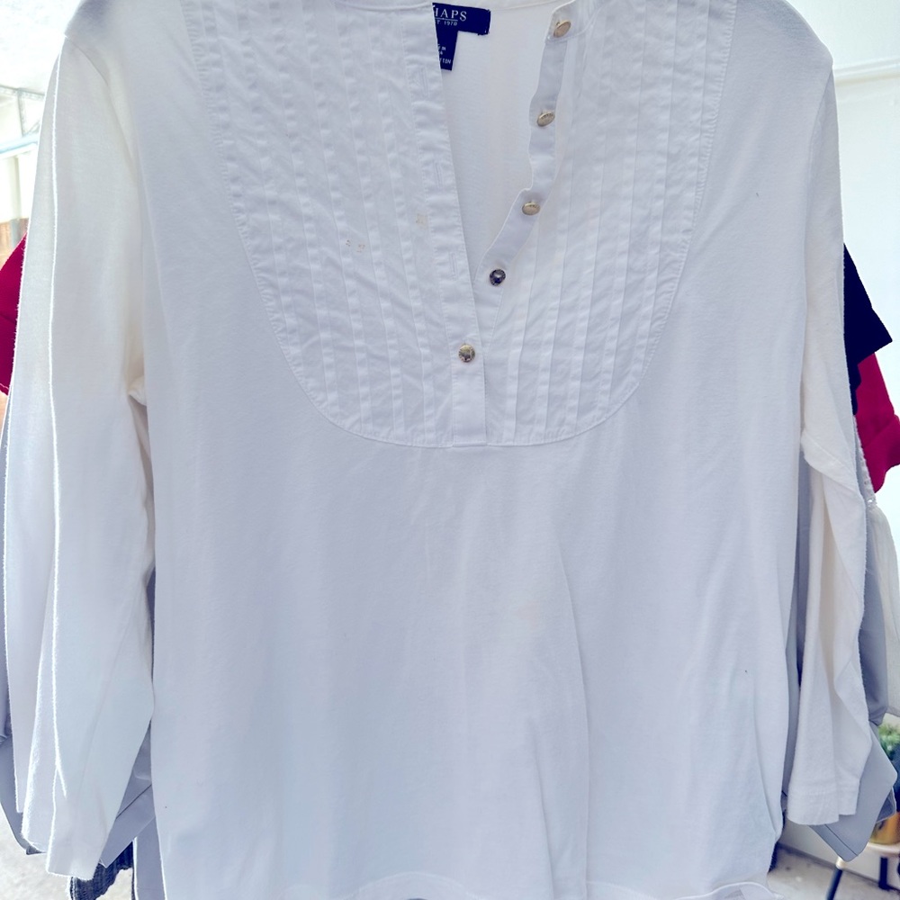 Neat little white shirt with five gold buttons.
